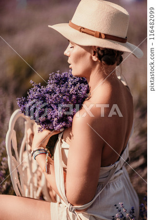 woman sitting in a field of lavender and wearing a straw hat. She is smiling and holding a bouquet of flowers. Scene is peaceful and serene, as the woman is surrounded by the beauty of nature woman sitting in a field of lavender and wearing a straw hat. She is smiling and holding a bouquet of flowers. Scene is peaceful and serene, as the woman is surrounded by the beauty of nature 116482099