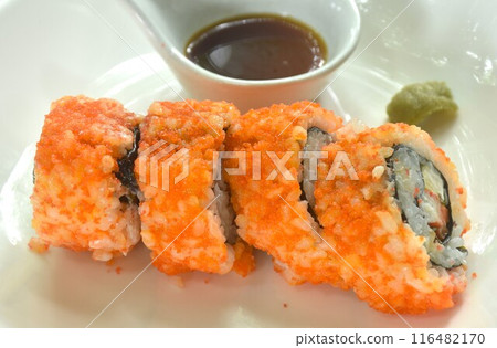 California roll topping shrimp egg stuffed maki sushi rice filling sweet egg and pickled cucumber wrapped by seaweed with wasabi dipping soy sauce on plate  116482170