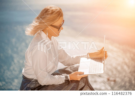 Business woman on nature in white shirt and black skirt. She wor 116482376