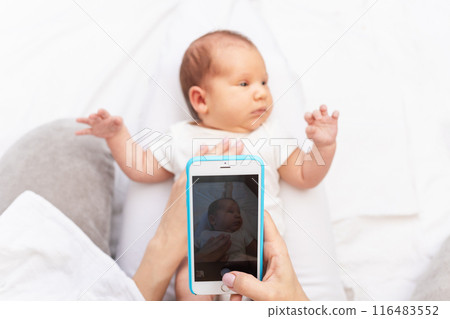 Mom Taking Photo of Newborn Baby with Smartphone.. 116483552