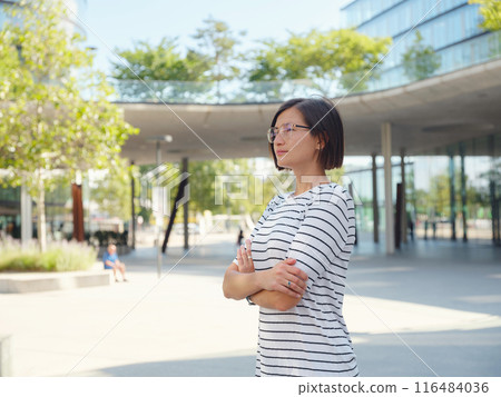 Asian woman over background of modern urban architecture in Vienna. 116484036