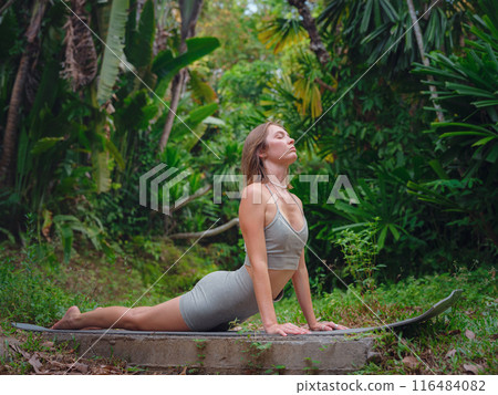 Beautiful woman practices yoga in Crabi, Thailand 116484082