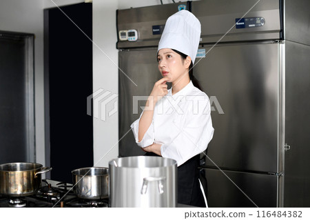 Young chef asian woman thinking in the kitchen 116484382