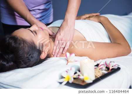 Thai oil Ayurvedic massage on bed to Asian woman by masseuse in spa Thai oil Ayurvedic massage on bed to Asian woman by masseuse in spa 116484464
