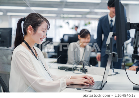 A pregnant woman doing desk work in the office A pregnant woman doing desk work in the office 116484512