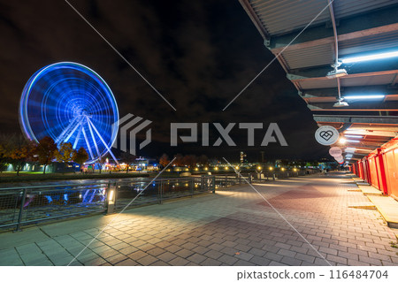 Montreal, Quebec, Canada - October 18 2022 : Old Port of Montreal, La Grande roue de Montreal Ferris wheel illuminated at night. 116484704