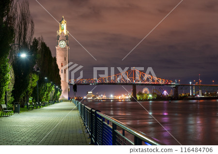 Old Port of Montreal Clock Tower and Jacques Cartier Bridge illuminated at night. Montreal, Quebec, Canada. 116484706