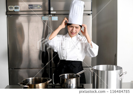 Young chef asian woman having trouble in the kitchen 116484785
