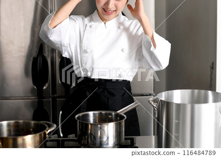 Young chef asian woman having trouble in the kitchen 116484789