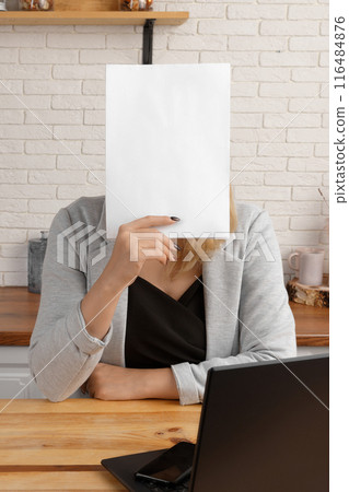 Businesswoman with blank paper, feeling overwhelmed in kitchen office. 116484876