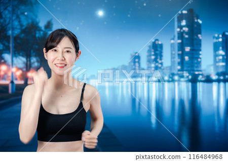 Woman running in the city at night Woman running in the city at night 116484968