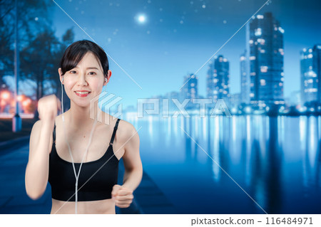 Woman running in the city at night Woman running in the city at night 116484971