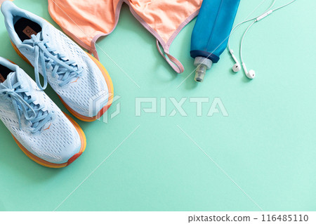 Flat lay with sport equipment on light green background Flat lay with sport equipment on light green background 116485110