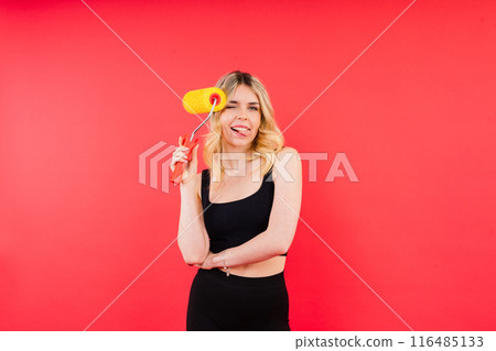 Young minded employee laborer handyman woman choosing roller brush paint 116485133