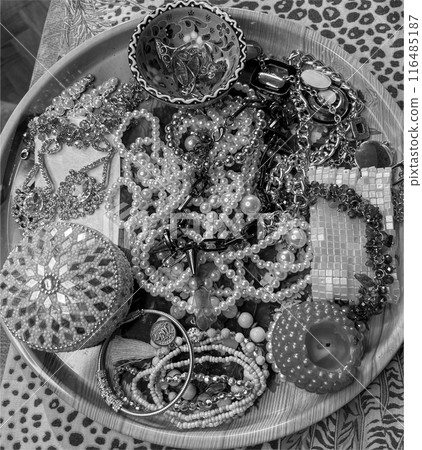 women's hands with painted nails on a background of jewelry 116485187