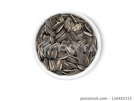 Bowl with healthy black sunflower seeds with shell isolated on white background. Bowl with healthy black sunflower seeds with shell isolated on white background. 116485315