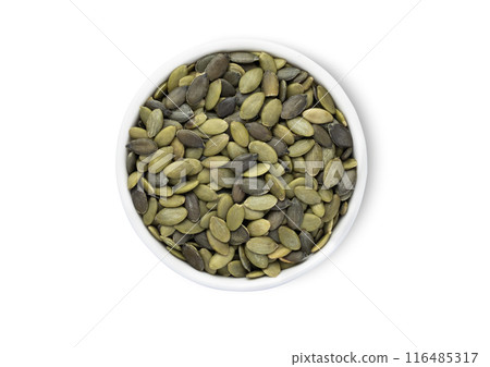 Bowl with healthy green pumpkin seeds isolated on white background. Bowl with healthy green pumpkin seeds isolated on white background. 116485317