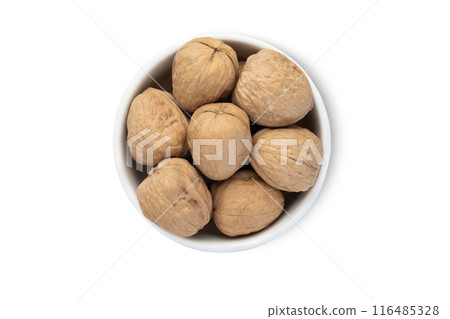 Ceramic bowl with organic walnut nuts with shell isolated on white background. 116485328