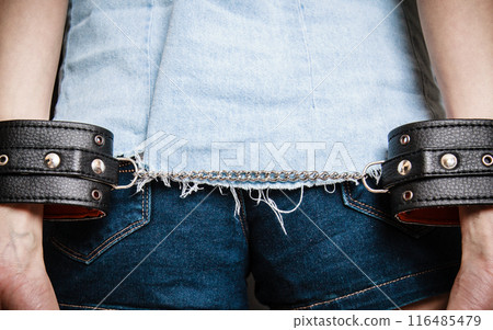 Arrest. Leather handcuffs on hands prisoner girl 116485479