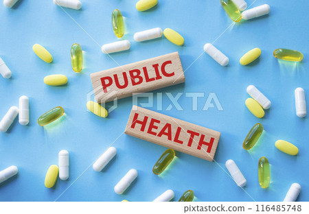 Public Health symbol. Concept word Public Health on wooden blocks. Beautiful blue background with pills. Medicine and Public Health concept. Copy space 116485748