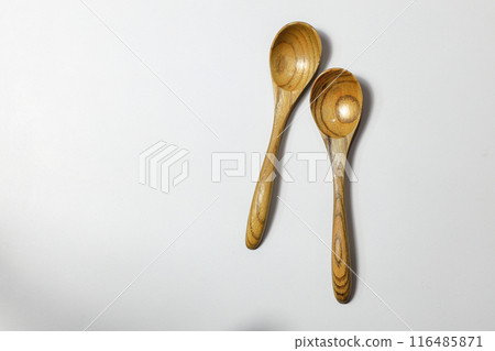 Empty wooden spoons isolated on white Background. 116485871