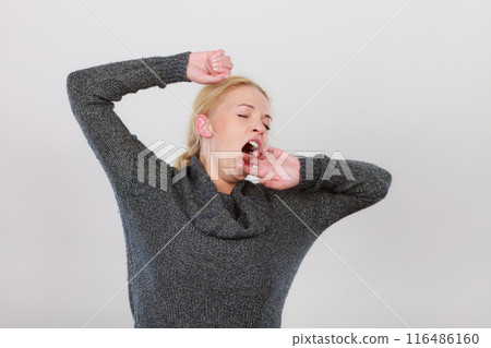 Sleepy, tired, yawning woman stretching arms Sleepy, tired, yawning woman stretching arms 116486160