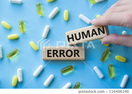 Human Error symbol. Concept word Human Error on wooden blocks. Beautiful blue background with pills. Doctor Hand. Medicine and Human Error concept. Copy space Human Error symbol. Concept word Human Error on wooden blocks. Beautiful blue background with pills. Doctor Hand. Medicine and Human Error concept. Copy space 116486190