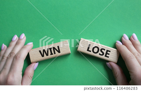 Win or Lose symbol. Concept word Win or Lose on wooden blocks. Businessman hand. Beautiful green background. Business and Win or Lose concept. Copy space Win or Lose symbol. Concept word Win or Lose on wooden blocks. Businessman hand. Beautiful green background. Business and Win or Lose concept. Copy space 116486283