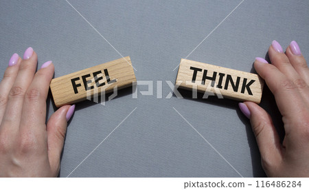 Think or Feel symbol. Concept word Think or Feel on wooden blocks. Businessman hand. Beautiful grey background. Business and Think or Feel concept. Copy space Think or Feel symbol. Concept word Think or Feel on wooden blocks. Businessman hand. Beautiful grey background. Business and Think or Feel concept. Copy space 116486284