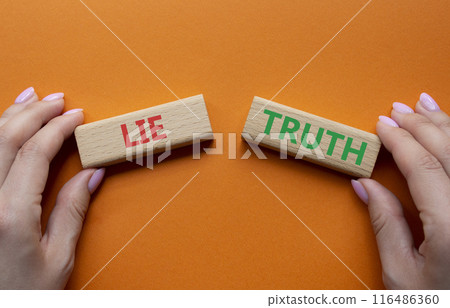 Truth or Lie symbol. Concept word Truth or Lie on wooden blocks. Businessman hand. Beautiful orange background. Business and Truth or Lie concept. Copy space 116486360