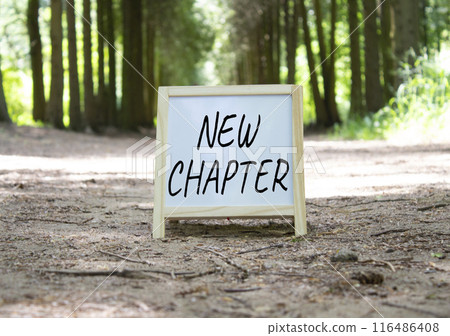New Chapter symbol. Concept word New Chapter on white chalk background. Beautiful forest background. Business and New Chapter concept. Copy space New Chapter symbol. Concept word New Chapter on white chalk background. Beautiful forest background. Business and New Chapter concept. Copy space 116486408