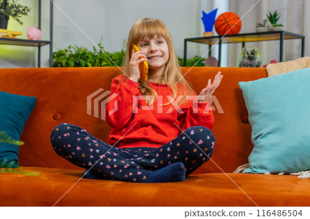 Happy surprised child girl having pleasant conversation phone call good news enjoying talking gossip 116486504