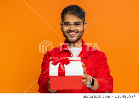 Smiling man presenting birthday gift present box stretches out hands, promotion discount sale 116486554