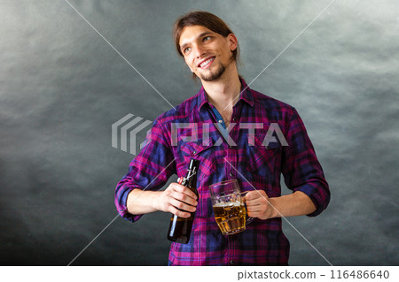 Tapster fills stein from bottle. 116486640