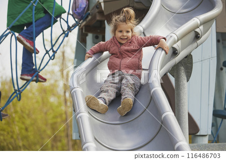 Charming child playing on a playground in Denmark 116486703
