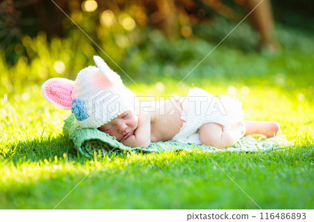 First Easter for baby boy. Kid and bunny. 116486893
