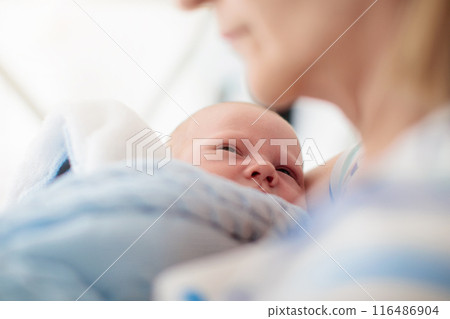 Swaddling newborn child. Baby in swaddle blanket. 116486904
