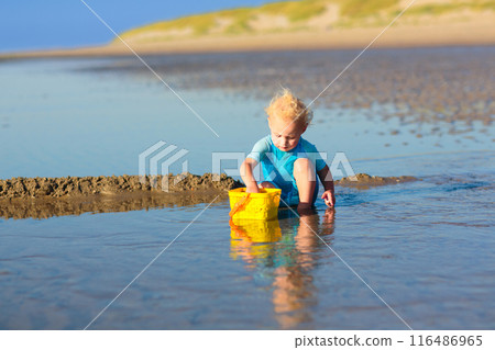 Kids playing on beach. Children play at sea. Kids playing on beach. Children play at sea. 116486965