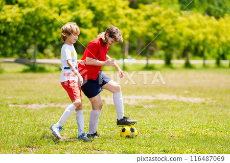 Child playing football. Kids play soccer. 116487069