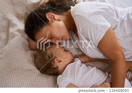 Mother and baby peacefully sleeping together, showcasing the bond between parent and child 116488093