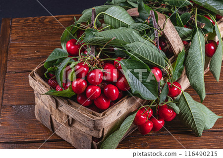 ripe cherries in a box on the table close up top view ripe cherries in a box on the table close up top view 116490215