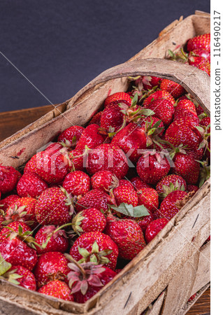 ripe strawberries in wooden wicker box on table close up ripe strawberries in wooden wicker box on table close up 116490217