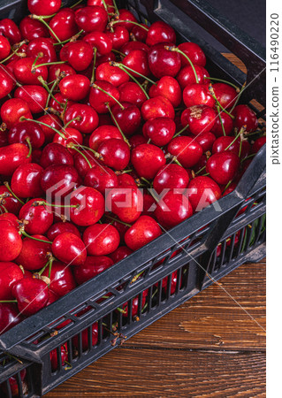 ripe cherries in a plastic box on the table top view ripe cherries in a plastic box on the table top view 116490220