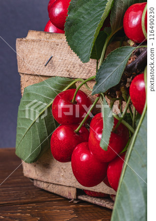 ripe cherries in a box on the table close up 116490230