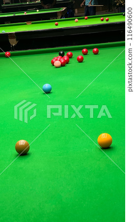 Playing snooker balls on the green game table  in public place 116490600