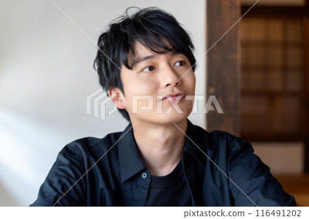 A young man relaxing in a Japanese-style room 116491202