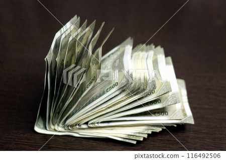 Indian Rupees 500 currency notes on the wooden table Indian Rupees 500 currency notes on the wooden table 116492506