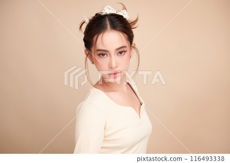 Beautiful young asian woman with clean fresh skin on beige background, Face care, Facial treatment, Cosmetology, beauty and spa, Asian women portrait. Beautiful young asian woman with clean fresh skin on beige background, Face care, Facial treatment, Cosmetology, beauty and spa, Asian women portrait. 116493338