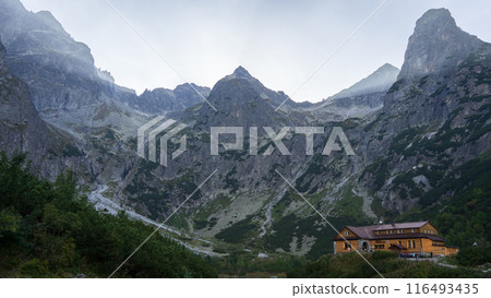 Wooden mountain lodge surrounded by massive rock mountains, Europe, Slovakia Wooden mountain lodge surrounded by massive rock mountains, Europe, Slovakia 116493435