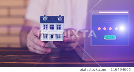 A man's choice of premium real estate as storage of money, model of a house 116494605